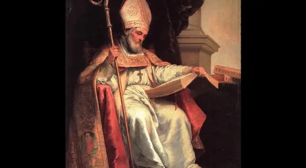 Isidoro de Sevilla, obispo con mitra y báculo, lee un libro.