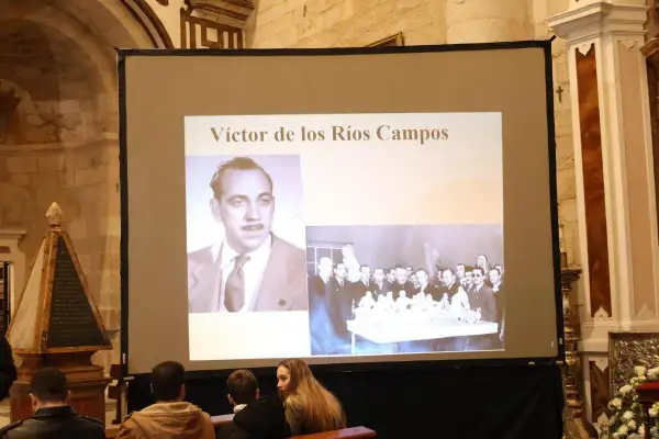 Proyección de imágenes sobre Víctor de los Ríos Campos, con su retrato y una escena grupal.